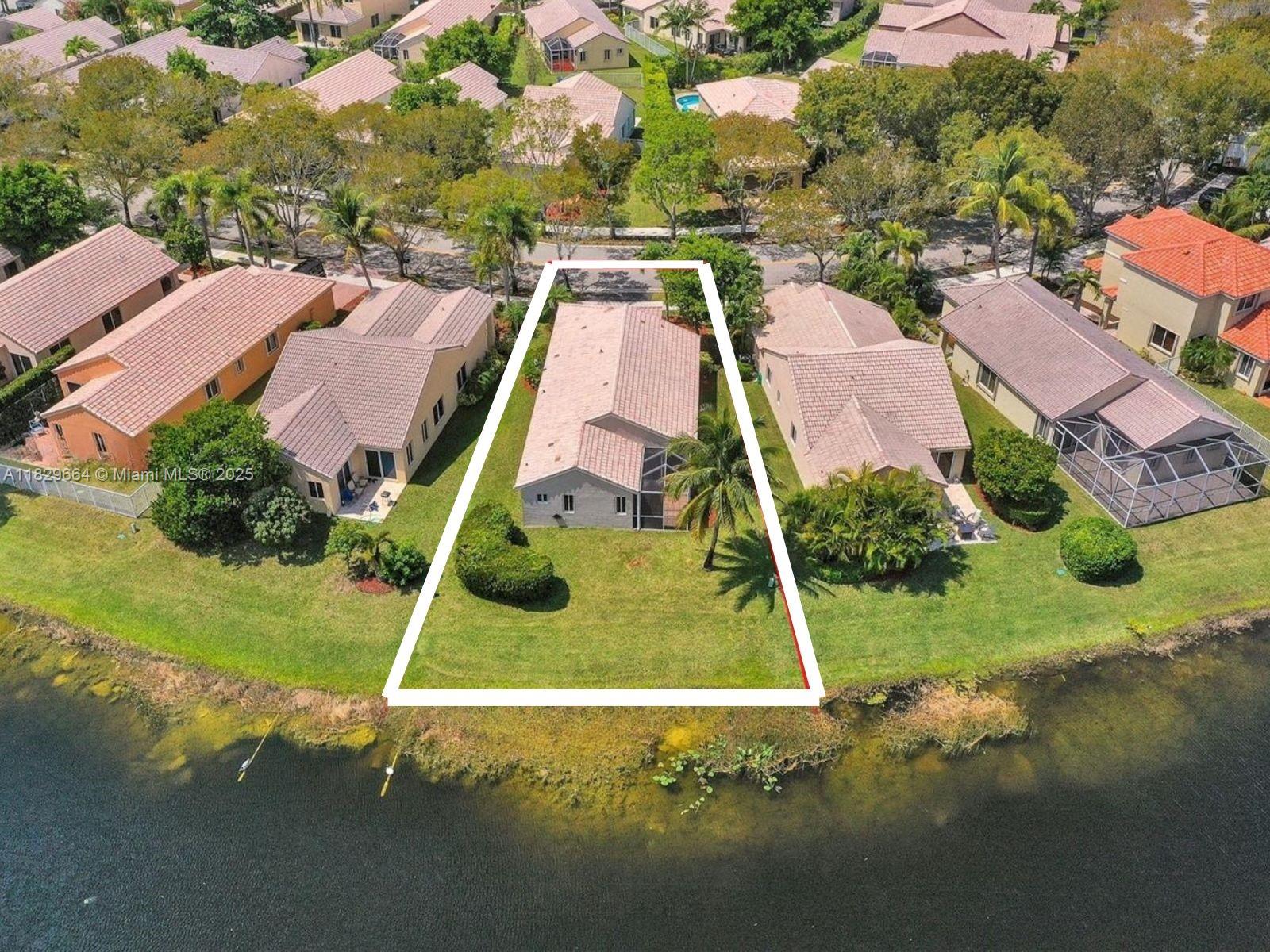 Beautifully remodeled 3-bedroom, 2-bath home in the exclusive Mahogany Ridge community of Weston. Enjoy stunning lake views from the master bedroom and spacious living areas filled with natural light. The modern kitchen features white cabinetry, marble-style countertops, a large peninsula with seating for four, and stainless steel appliances. The open floor plan seamlessly connects the kitchen, dining, and living spaces, perfect for entertaining. Relax in the private backyard with panoramic lake views and a cozy fire pit. Additional highlights include a two-car garage and soon-to-be-installed impact windows for safety and energy efficiency. Located in a secure, family-friendly neighborhood with access to top schools and parks. Don’t miss this exceptional home!