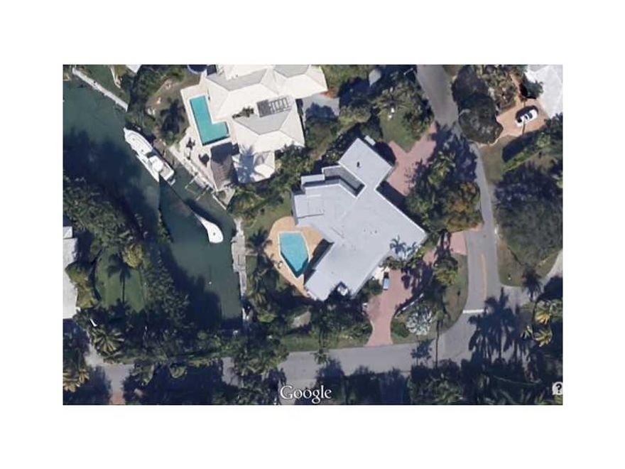Best corner lot on the water in Key Biscayne, with 19,000+sq.ft. per survey, at corner of Island and Cape Florida Drives, with a driveway to each street . Acai and other exotic fruit trees. Protected dock for large boat and direct access to the Bay. Bucol ic privacy around the pool and deck, with granite topped bar. Two large master suites with secret and peaceful garden. Kitchen and family room open to pool and dock area. Library/office suite or fifth bedroom. New roof; three A/C units/zones. Beach club.