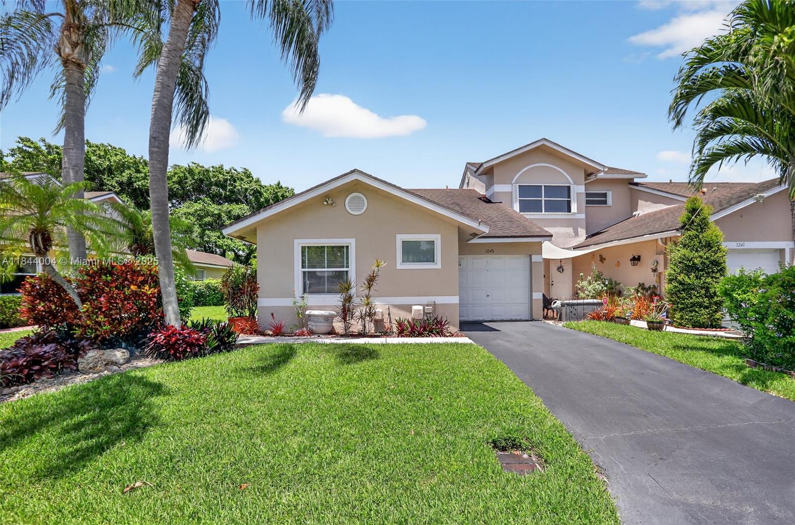 Beautiful corner unit with no rear neighbors in a peaceful, well-maintained community, featuring impact windows and doors, wood, laminate and ceramic flooring, renovated kitchen and bathrooms, stainless steel appliances, and professional landscaping. Enjoy the open, partially covered private screened patio featuring elegant porcelain flooring. This well-maintained, pet-friendly community offers a Clubhouse/Party room, heated pool, Jacuzzi and tennis court! The seller has already covered the assessments, a new roof is currently being installed, and fresh paint will follow right after. The community is conveniently located with easy access to both I-95 and the Turnpike, and it's just 15-20 minutes from the beach. It's just a 5-minute trip to the grocery store and Walmart.