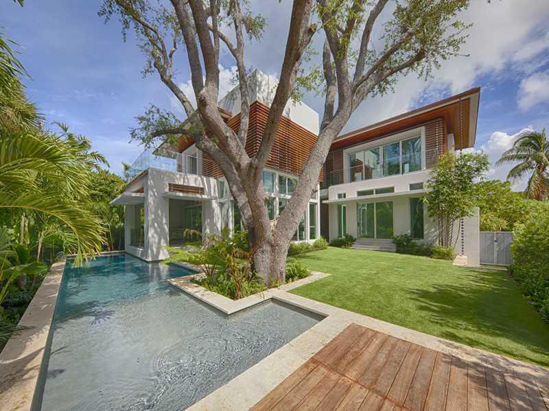 Stunning new high end "Tropical Modern" home designed by Cesar Molina. Open floor plan-living, family, dining and kitchen w/12ft ceilings, marble & wood floors. Kitchen has Viking gas stove, SubZero refrigerator & bianco vintage granite. Smart lighting & alarm system. 2nd floor family room could convert to 5th bedroom, opens to large balcony. Covered terrace with summer kitchen incl. Viking BBQ. Large pool w/pool deck. Designer tropical landscape throughout. KB Beach Club membership included. A must see!