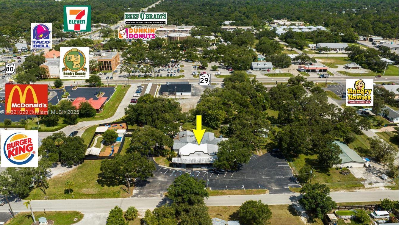 4,711+/- SF BUILDING, CURRENTLY SET UP FOR A RESTAURANT AND BAR, BUT FLEX- SPACE THAT COULD HOUSE OFFICES, DAY CARE BUSINESS, ETC.! Located on 1+ acre with improvements including main building; 1,250+/- SF f full 3/2 apartment for owner, manager, or security; detached private garage; separate screened porch with built-in barbecue building; and storage barn. Property boasts beautiful LaBelle oaks and a huge asphalt paved parking lot along with partial fencing for privacy and security. Main building is concrete block with metal roof, built in 1991 and totally renovated in 2018 and 2021. Restaurant kitchen includes a commercial hood and cooler. There are two 220 outlets under the hood and there’s a freshwater line for pot filling etc. The building also features a front canopy patio.