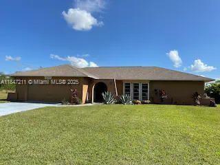 Waterfront Pool Home in great NE Cape Coral location. Fresh paint inside and out. Open kitchen has
Granite counter tops, wood cabinets, and center island along with Stainless Steel Appliances. Master
Bedroom overlooks pool and lake. Tile floors throughout except new carpet in bedrooms. New roof in
2015 and new pool and pool heater in 2016. Newer a/c unit with premium landscaping package
