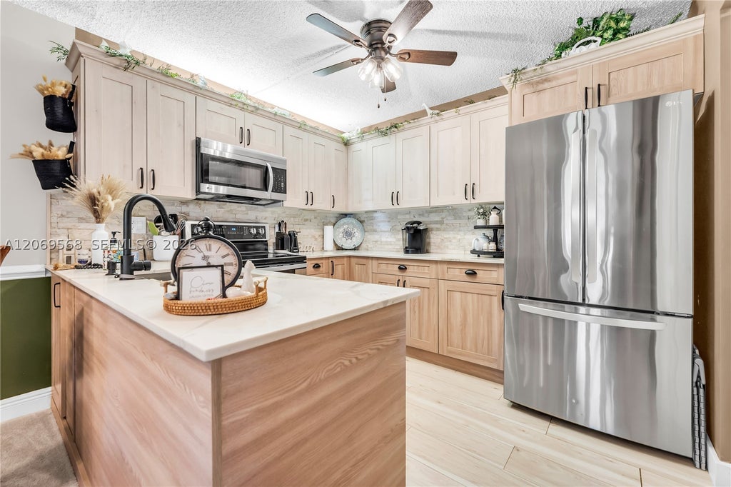 Photo of 3561 Pine Tree Ct #D-1, Green Acres, FL 33463 (MLS # A12069568)