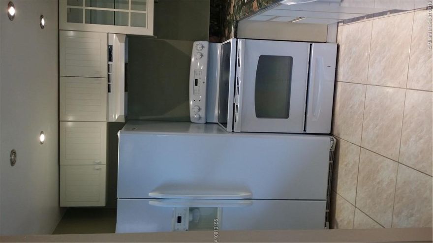 Immaculately clean corner unit on ground floor with peaceful golf and water views.  Back patio converted into additional room/Great for extra room or office space./ Real hard wood floor and beautiful tile throughout the unit and very nice granite kitchen counter tops. /  Enjoy the peaceful views and quiet lifestyle in this 55+ community.  The development amenities include: community pool, tennis courts, a  theater, exercise room and more.   A great central location in Sunrise with shopping and dinning.