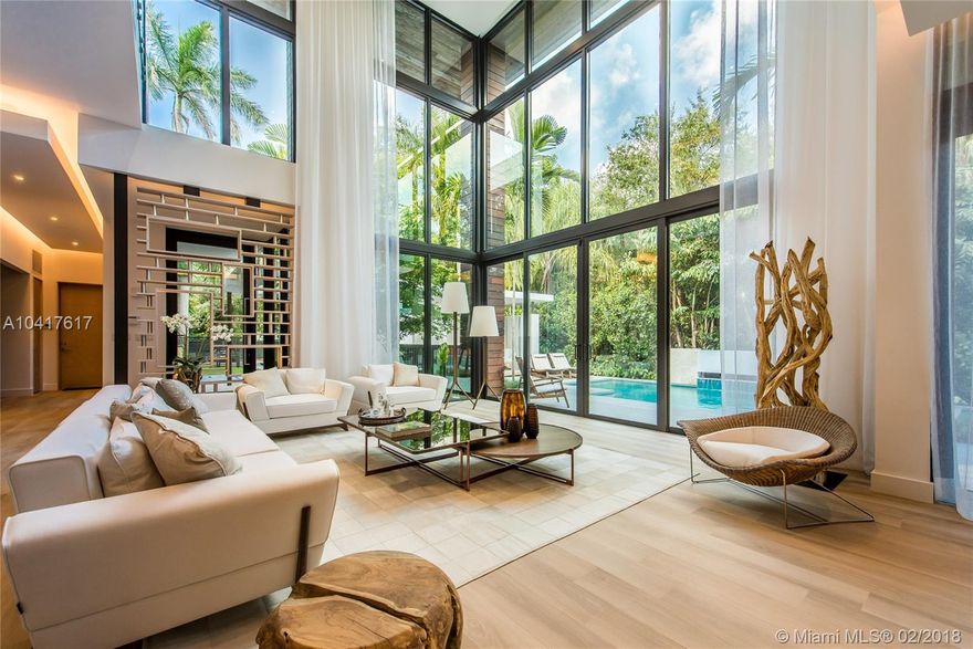 Spectacular Tropical Modern masterpiece designed by acclaimed architect Charles Treister, set within a lush botanical garden behind a custom coral rock wall and gate. The quality of finishes, fixtures and attention to detail is unsurpassed by any new construction home in the Grove. 23 ft ceilings and walls of glass create a seamless blending of interior and fabulous exterior spaces. Custom Italian kitchen. Green and Smart Home technologies. Developed by Andrew Rasken and Charles Treister.