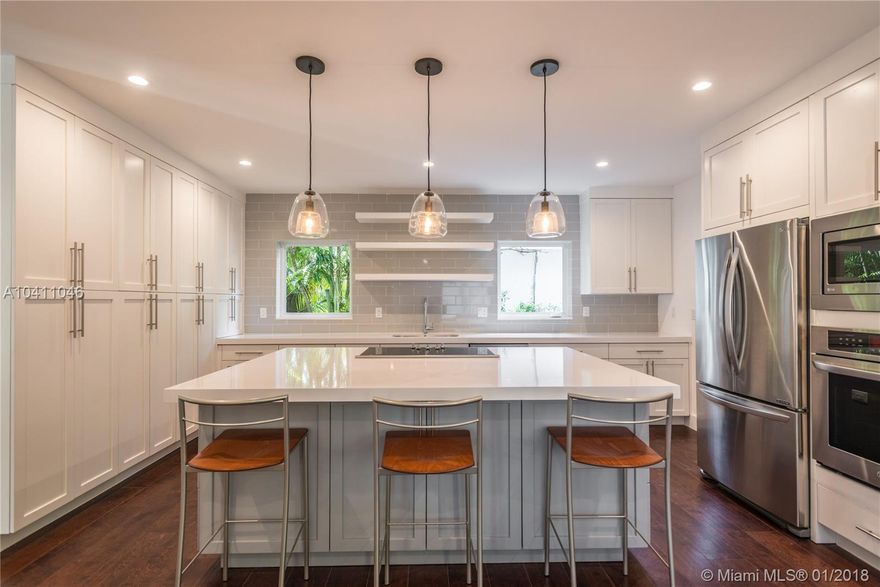 Stunning new South Gables renovation with open living spaces, hardwood flrs, impact glass, beautiful light and outstanding finishes. Gorgeous white/stainless/quartz island kitchen w/ abundant cabinets, dining area. Adjacent great room has fireplace and opens to private back yard. Split plan presents spacious BR and bath on 1st floor, large master suite upstairs w/ walk-in closet, marble bath, separate shower, slipper tub. 2 more BRs share a sleek hall bath.  MUCH MORE!