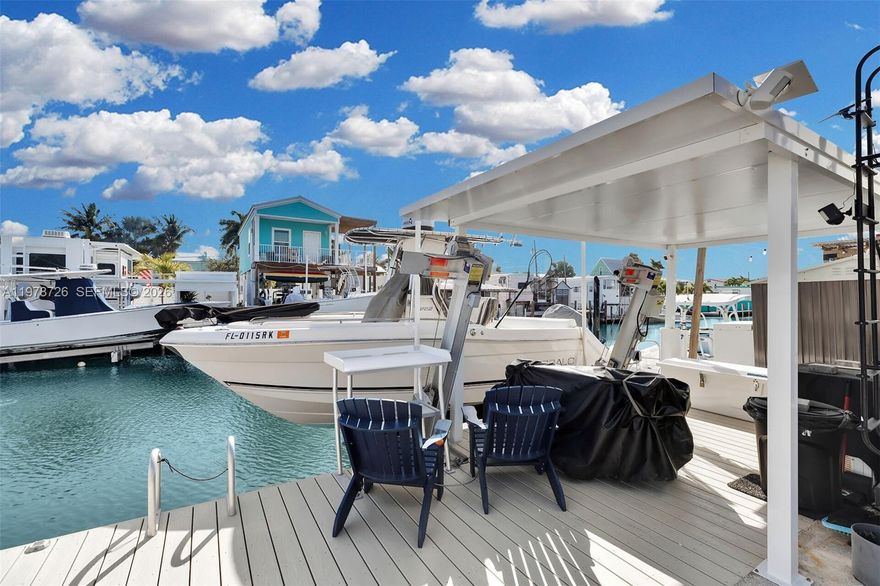 Canal-front opportunity in Keys by the Sea at 6099 Overseas Highway, Unit 55W. This waterfront lot features a newly rebuilt dock and installed boat lift, offering immediate boating access in the heart of Marathon. A 2022 travel trailer currently located on the property is included as personal property, allowing for immediate use while planning future improvements. Seller states there is a ROGO exemption. Buyer to independently verify building eligibility and permitting status with the City of Marathon. Located in Keys by the Sea, this community is conveniently situated near dining, shopping, marinas, and open water access. A rare opportunity to secure canal frontage with existing dock infrastructure and flexible use potential in the Florida Keys.