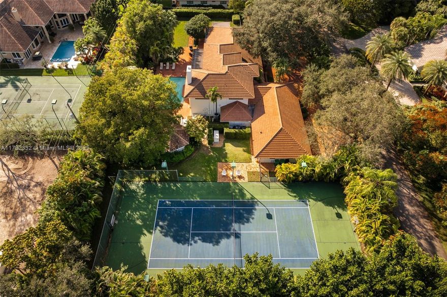 Stunning 6-bed/7-bath Hollub estate with lighted tennis court on a private road in gated Pinecrest Grove (9 homes). Situated on a full acre, it offers timeless craftsmanship, top schools, and quick access to recreation, shopping, and dining. The first floor boasts a primary suite with adjoining office, elegant library with fireplace, expansive family room with bar, game room, and a chef’s kitchen overlooking the heated pool, patio, gazebo, and grounds. Staff quarters and a cabana bath add convenience. Four spacious bedrooms grace the second floor. Enjoy a resort-style pool, gym, and manicured landscaping. Additional features include a 3-car garage, impact windows/doors, generator, and a 2010 Hollub renovation. Impeccably maintained and move-in ready.