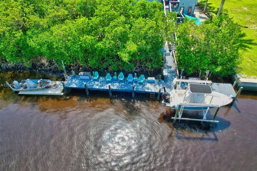 This furnished waterfront compound is on a deep-water canal(7ft at low tide & 11 ft at high) with a 70ft dock with a boat lift and float on dock. Easy access to the Ten Thousand Islands and the Gulf of America for world class fishing, kayaking, and sunset cruises. Private location near Everglades National Park with abundantly diverse wildlife such as manatees, river otters, and over 300 species of birds. Nature lovers will enjoy an array of over 750 native plants including orchids, mangroves, and bromeliads. Property features include: detached workshop, 4 car garage bunker, and substantial parking. This property offers a unique blend of practical Florida living with modern features. Upstairs is the main house with 3 beds and 2 baths. Large living space, split bedrooms, and private balcony with grill and fire pit. Completely remodeled downstairs 2 bed 1 bath and 1 bed 1 bath units with granite counters, stainless appliances, new cabinets, new floors, and new bathrooms. There is a pool in the back yard for your relaxation and enjoyment. Laundry facility on site. Great location just 35 miles away from Naples and only 42 miles to Miami.