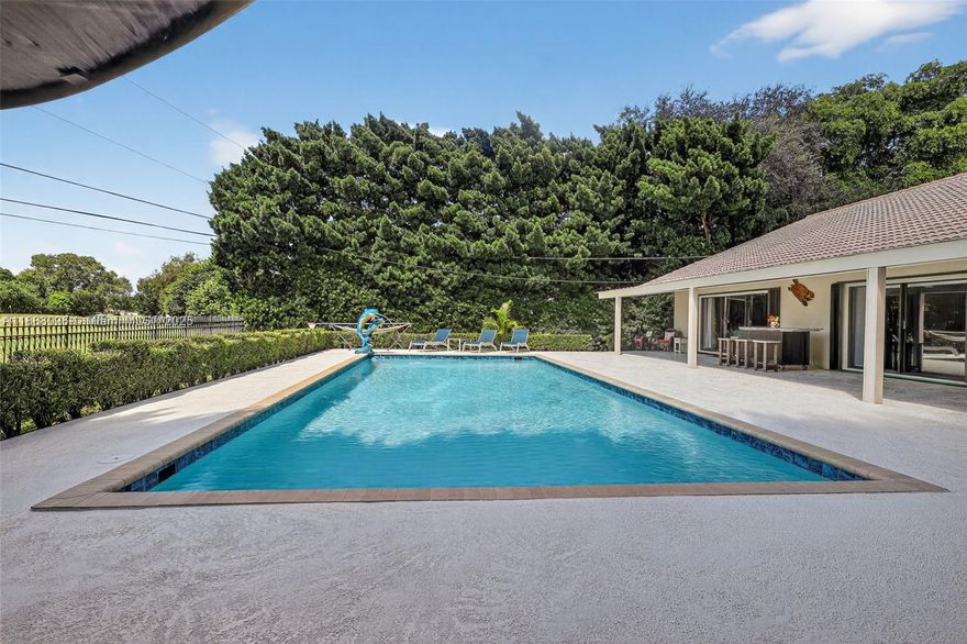 This fully updated home sits on one of the LARGEST and most PRIVATE lots in the area and delivers the kind of long-range views buyers chase but rarely find. Prime location near A-rated schools, parks, dining, shopping, major highways, airports, and beaches.

Outdoor living is a standout, featuring an OUTDOOR COVERED LOUNGE AREA, bar, resurfaced pool, freshly painted deck, screened patio, accordion shutters, and new pavers throughout. Perfect for relaxing or entertaining while enjoying warm Florida breezes and UNOBSTRUCTED SUNSET VIEWS!

Inside, the home feels crisp and modern with vaulted ceilings, new marble floors, upgraded lighting and fixtures, new cabinetry and countertops, a new range hood, and stainless steel appliances. Additional highlights include a wood-burning fireplace, dual-zone A/C, laundry room, attic storage, and a spacious primary suite with walk-in closet, vanity area, and dual sinks.

Homes offering this level of privacy, upgrades, and panoramic views are extremely rare — this is the one buyers wait for!