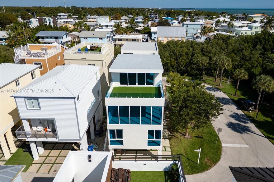 Beautiful turnkey modern new construction home. Corner lot with water views. Amazing roof deck with entertainment room on top floor, giving an extra floor of living space. Open floor plan and perfect for entertaining or large families. Private community of Key Largo Ocean Resort, packed with brand new amenities such as pool, clubhouse, tennis & basketball courts, clubhouse, playground, gym, fishing pier and community ramp. See video for virtual tour.