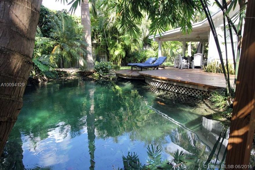 South Grove old Florida style home w/ 2 lagoon coral rock swimming pools on a mature tropical garden.Warm comfort & sophisticated details vaulted ceilings,wood floors,updated kitchen with European cabinets,stainless steel appliances & granite counter tops-split floor plan-open & bright.Large Florida room w/ serene garden views.Security fenced property w/ electric gate! Needs TLC.Roof covered terrace can be enclosed adding approx. 300 FT. $3,000 Bonus to Selling Agent on offers executed by February 5,2016.