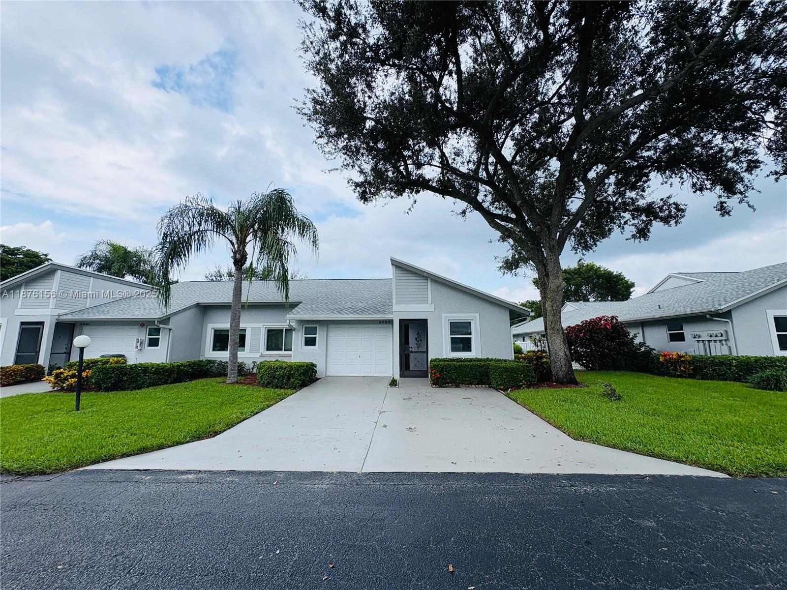 Welcome to this beautifully updated and cozy corner unit, one of the few with its own garage plus two additional parking spaces right in front. Thoughtfully renovated and well maintained, it features brand-new hurricane-impact windows (2025), a newer roof (2024), fresh exterior paint (2024), and a new water heater (2023). The enclosed Florida room with A/C adds year-round living space, while the bright eat-in kitchen and open layout create a warm, inviting feel. Inside, enjoy stylish updates including renovated bathrooms, modern fixtures, and upgraded flooring. Move-in ready, this home offers comfort and peace of mind within a vibrant 55+ community featuring resort-style amenities such as tennis, pool, clubhouse, and a full calendar of activities.
