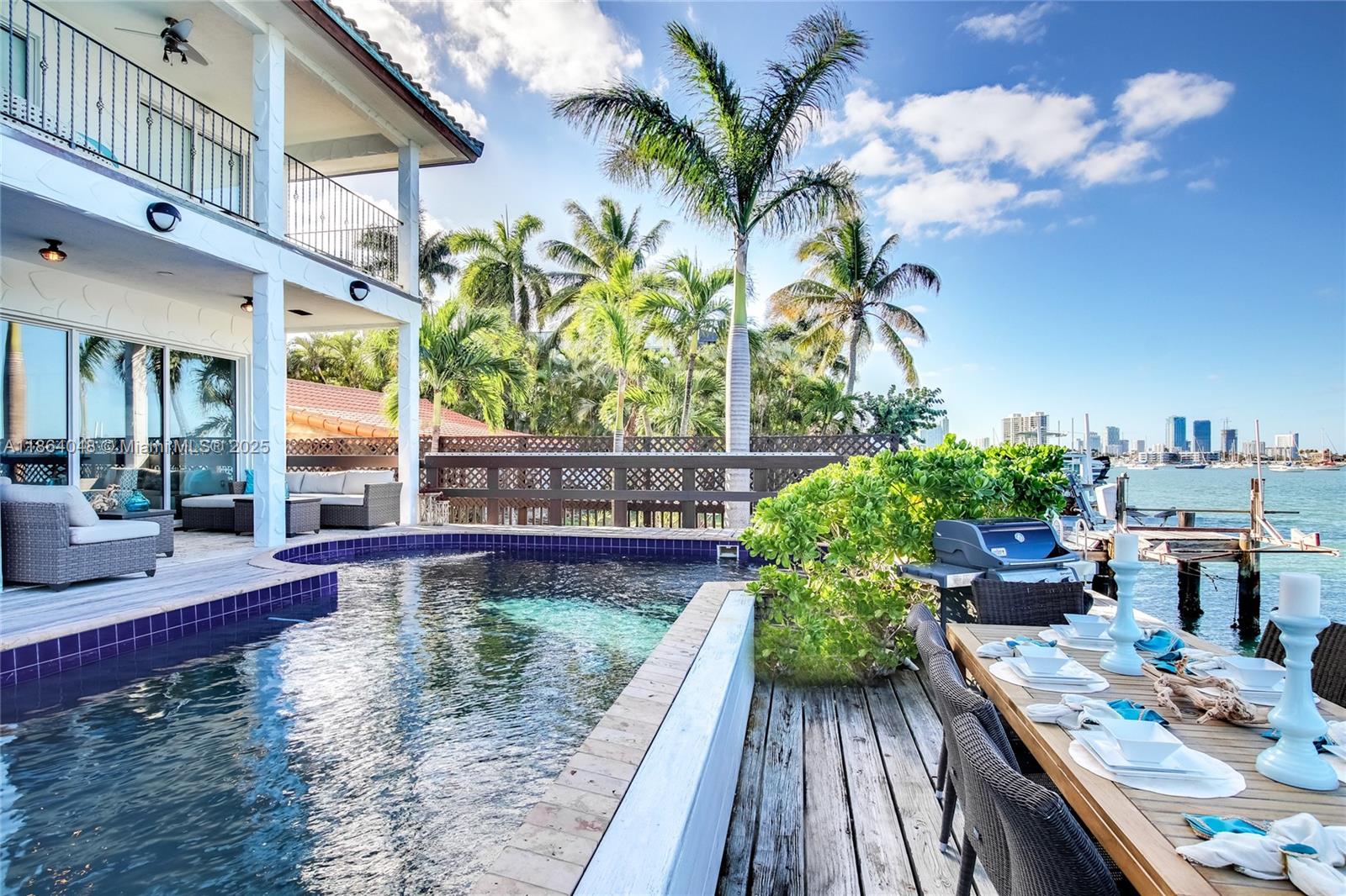 Gorgeous waterfront estate on exclusive Palm Island with guest house and 5 car garage. Enjoy sweeping bay views from your private dock, pool deck, and balconies. Designed for both grand entertaining and intimate living, the open-concept layout flows seamlessly from family room to the gourmet kitchen and wet bar—perfect for those looking for exclusivity, boat lovers, and families alike. A separate guest suite with its own full kitchen and bath offers privacy and flexibility for visiting family, staff, or long-term guests. Includes 5-car garage and 2 boat slips. Located on prestigious Palm Island, residents enjoy exclusive access to tennis courts, a covered playground, basketball court, picnic areas, and 24/7 guard-gated security—ensuring peace of mind and a true sense of community.