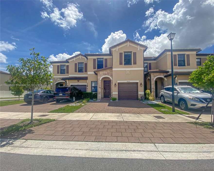 Discover your new home in the Aquabella gated community of Hialeah Gardens. This modern 2020-built townhouse offers 4 bedrooms, 2.5 bathrooms, and over 2,000 sq ft of living space, including a living room, dining room, and family space. The home features tile floors downstairs and wood flooring upstairs. Hurricane impact windows provide protection, and the kitchen has quartz countertops and stainless steel appliances. Enjoy the backyard with turf and an AC-equipped garage that can be used as a traditional garage, gym, office, or extra room. Aquabella offers resort-style pools, gyms, green areas, lakes, and play areas. Nearby are great schools and shopping centers with childcare, restaurants, shops, pharmacies, gas stations, and banks. Comfort and an active lifestyle await you.