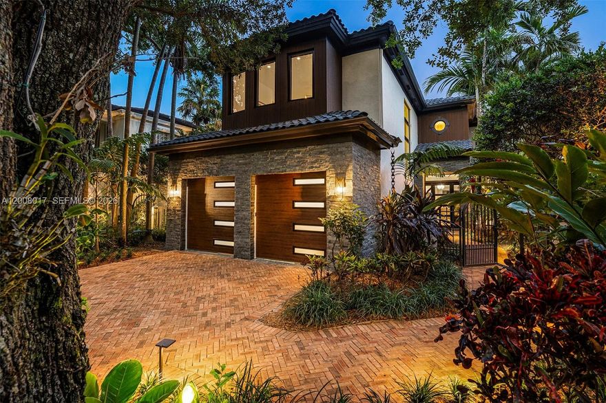 Tucked on a truly enchanting, oak-shaded lane just off historic Sunset Drive, this stately 2-story contemporary residence enjoys a premier, close-in location at the convergence of Coral Gables, Ponce-Davis & High Pines. Its 5 bedrooms & 4 baths were completely reimagined w/ a top-to-bottom renovation. Every modern detail, high-end finish & statement fixture is brand-new. Sophisticated interiors feature elegant limestone flooring, a gorgeous granite gas fireplace, impact windows & doors, striking wall-hung marble countertops, stylish backlit vanities accenting spa-inspired baths, custom-built closets & thoughtfully placed recessed lighting that elevates ambiance throughout. Downstairs: Brand new kitchen features sleek, custom cabinetry & functional design, all-new, high-end appliances & a charming sunlit breakfast area. Formal living & dining rooms, & spacious family room flow seamlessly, opening to the beautifully redesigned backyard. A well-placed bdrm, full bath, laundry & 2-car garage complete the main level. Upstairs: A grandly scaled primary suite features an ultra-luxurious bath, a reading area & oversized walk-in closet w/ 2 entries. Two add’l en-suite bdrms, plus a fourth bdrm ideal for an office or nursery complete level 2. Outdoors: A limestone patio frames a lovely pool set amidst a lush mature landscape, creating a private tropical oasis. An exquisite, impeccable turnkey home in an idyllic neighborhood just minutes from the Gables, Grove and South Miami.