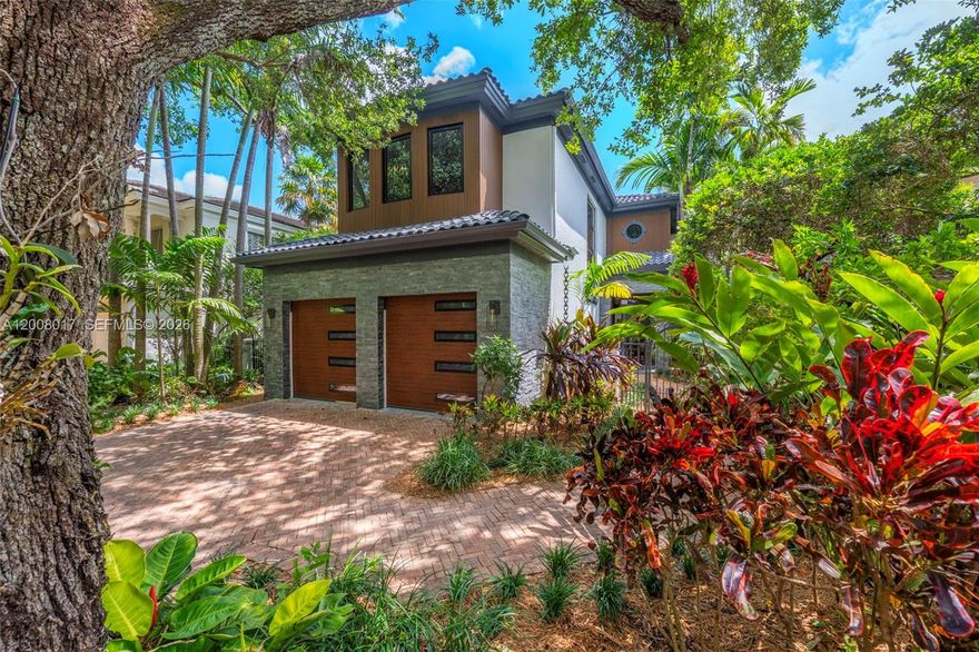 Tucked on a truly enchanting, oak-shaded lane just off historic Sunset Drive, this stately 2-story contemporary residence enjoys a premier, close-in location at the convergence of Coral Gables, Ponce-Davis & High Pines. Its 5 bedrooms & 4 baths were completely reimagined w/ a top-to-bottom renovation. Every modern detail, high-end finish & statement fixture is brand-new. Sophisticated interiors feature elegant limestone flooring, a gorgeous granite gas fireplace, impact windows & doors, striking wall-hung marble countertops, stylish backlit vanities accenting spa-inspired baths, custom-built closets & thoughtfully placed recessed lighting that elevates ambiance throughout. Downstairs: The fully renovated kitchen features sleek, custom cabinetry & functional design, all-new, high-end appliances & a charming sunlit breakfast area. Formal living & dining rooms, & spacious family room flow seamlessly, opening to the beautifully redesigned backyard. A well-placed bdrm, full bath, laundry & 2-car garage complete the main level. Upstairs: A grandly scaled primary suite features an ultra-luxurious bath, a reading area & oversized walk-in closet w/ 2 entries. Two add’l en-suite bdrms, plus a fourth bdrm ideal for an office or nursery complete level 2. Outdoors: A limestone patio frames a lovely pool set amidst a lush mature landscape, creating a private tropical oasis. An exquisite, impeccable turnkey home in an idyllic neighborhood just minutes from the Gables, Grove and South Miami.