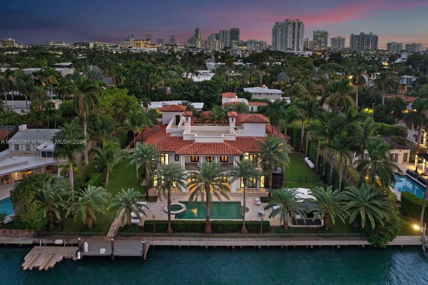 Discover the epitome of luxury living on coveted Sunset Island III with this extraordinary waterfront estate. Nestled on a sprawling 27,300-sf lot, this property boasts 156 feet of water frontage and direct Biscayne Bay access, perfect for yacht enthusiasts. This 7-bedroom, 9-bath masterpiece spans 11,790 sf featuring an impressive foyer with imperial staircase opening to a beautiful courtyard, expansive living areas, a gourmet chef's kitchen, and a home theater. The master suite offers two lavish baths and boutique-style walk-in closets. Outside, a resort-style oasis awaits with a heated pool, spa, summer kitchen, and rooftop terrace, ideal for entertaining. With a private dock, elevator, and lush landscaping, this estate is tailored for the most sophisticated and discerning buyers