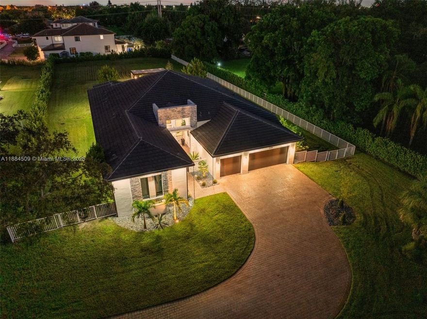Welcome to this stunning 2023 Turn Key!! residence in the heart of Southwest Ranches. Nestled on a private acre lot, this modern estate offers 3,700+ sq. ft. of living space with high ceilings, open-concept design, and floor-to-ceiling windows that flood the home with natural light. The gourmet kitchen with Calacatta marble countertops, top-of-the-line appliances + spacious island perfect for entertaining. The home features 4 bedrooms, 4.5 baths, and a luxurious primary suite with spa-style bathroom and walk-in closets. Designed for indoor-outdoor living, it boasts a covered terrace with a fully equipped summer kitchen, a 3-car garage, and plenty of parking space. With its prime location, new construction, and sophisticated finishes, this is a rare opportunity to own a ranch-style retreat