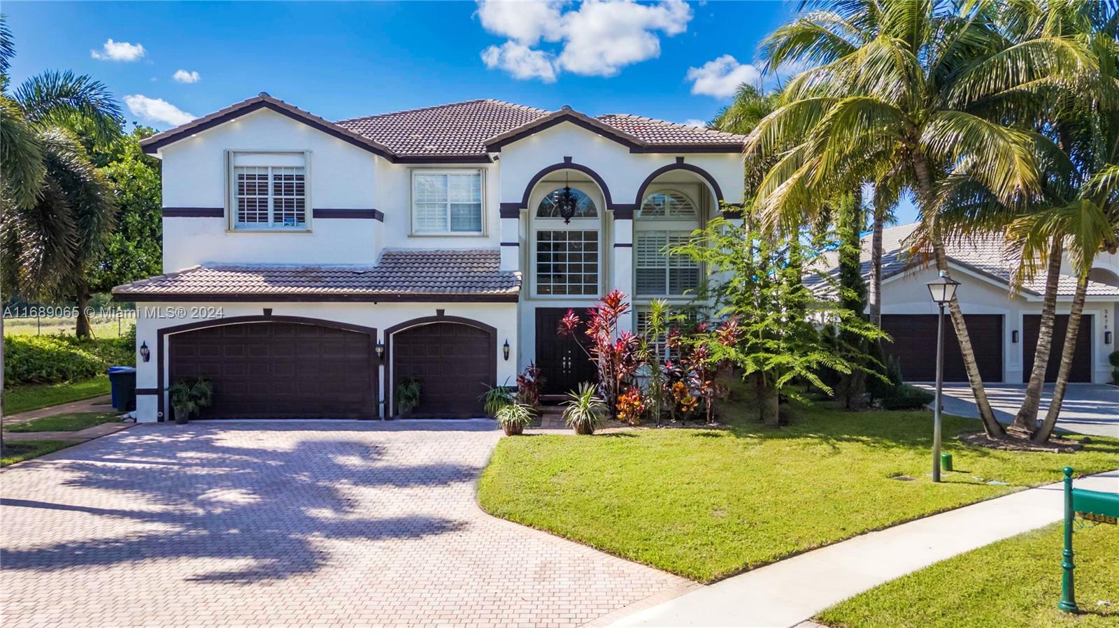 Welcome to the exquisite Victoria Model, located in the highly sought-after Sunset Lakes community! This stunning two-story home features 6 spacious bedrooms and 4 full bathrooms. Set on a large lot, the property includes an expansive driveway w plenty of room for parking & outdoor activities. Enjoy resort-style living w a beautiful pool, spa, & serene lake views, creating the perfect backdrop for relaxation a& entertaining. The chef-inspired kitchen is a true highlight, showcasing dark cherry wood cabinetry, sleek black granite countertops, & high-end SS appliances. The first floor also includes a full bath and a bedroom, ideal for guests or multi-generational living. With its open and elegant layout, this home is designed for both comfort and sophistication.