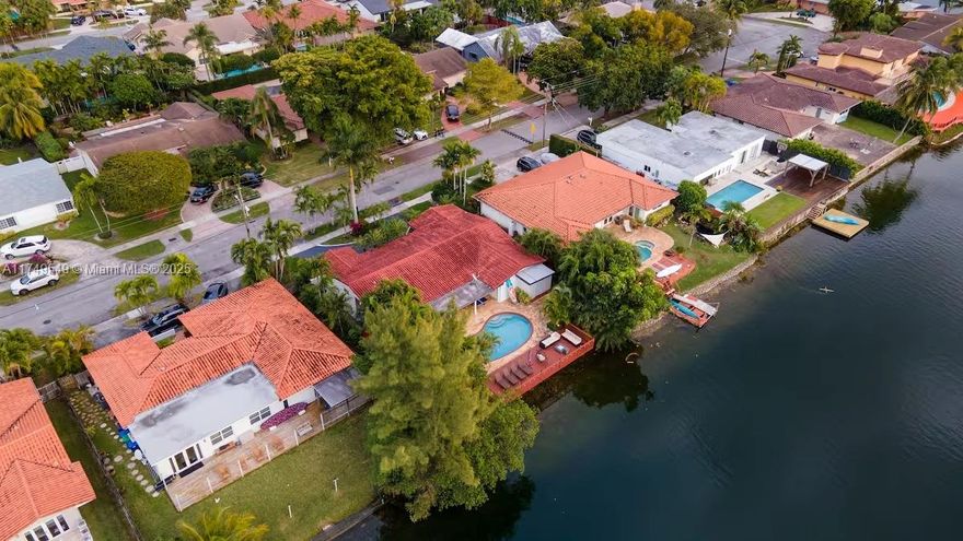 Espectacular 4 BD 3 full BA home with direct lake view from the moment you enter. Contemporary open floor plan. Wood floors in bedrooms. Living area has beautiful natural tiles thru out. Gourmet kitchen, quartz counter tops, top of the line S/S appliances, French doors, sophisticated security system & separate laundry room. Backyard has sparkling pool surrounded by wood deck & tropical landscaping overlooking lake.