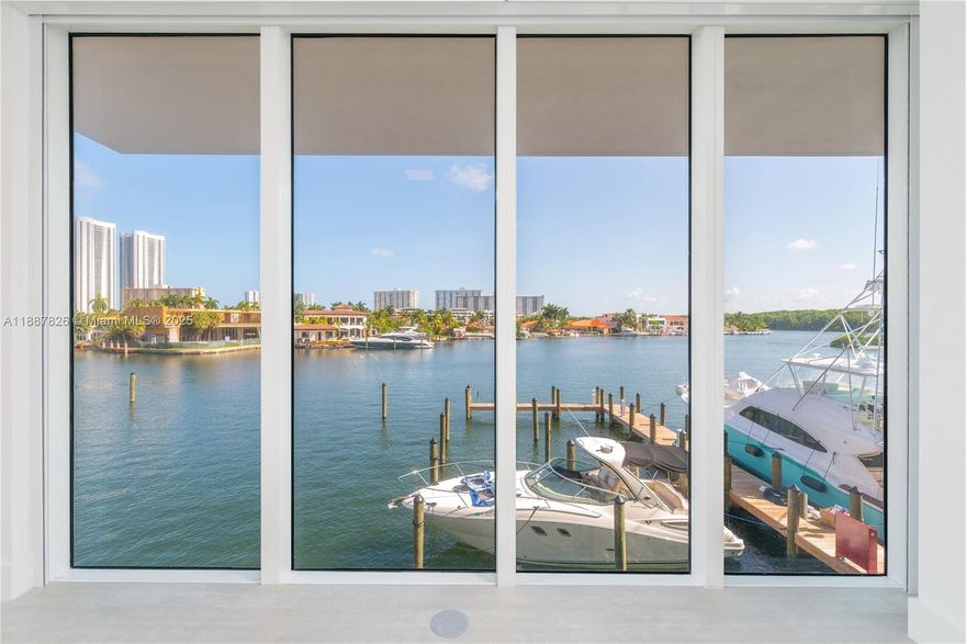 Rare 2-story corner townhouse at 400 Sunny Isles with soaring double-height ceilings and stunning direct bay views. This spacious and highly upgraded residence offers 2 bedrooms, 3 full bathrooms, plus a den that can easily be converted into a third bedroom or office. Modern finishes throughout include motorized shades, custom built closets, and elegant tile flooring. The bright open layout features floor-to-ceiling windows and a seamless connection to a private balcony with direct marina access, perfect for boaters. Two assigned parking spaces are included. Enjoy resort-style amenities such as a full-service marina, pool deck with cabanas, state-of-the-art fitness center, spa, tennis courts, and 24-hour concierge and security. Available December 1.