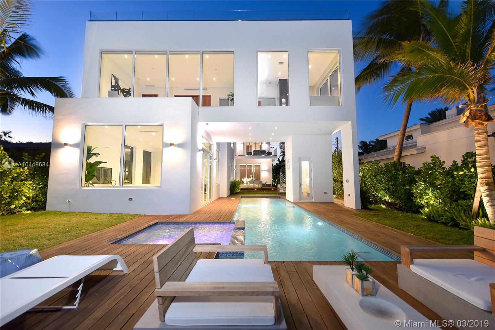Rare opportunity to own an award winning pristine Ultra-Modern waterfront masterpiece! This 5 bedroom luxury home boasts over 5000 Sq ft of living area and 53 ft of open water frontage. The exceptionally designed luxurious living space flawlessly connects interior with the exterior. Deluxe textures and exceptional finishes adorn the one of a kind design of this home. Inside, an incredible living room with dramatic 20+ ft ceilings, featuring a gourmet kitchen by SMEG, and custom Italian cabinetry throughout all bathrooms and closets; all with incredible water views. Pool and boat dock. Automated LED lighting conveniently highlight the lush landscaping. Enjoy the sunset from your private third floor terrace or master spa bath. This home has it all.