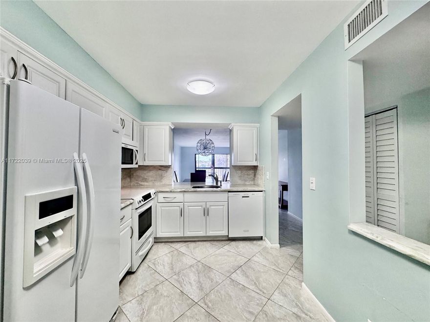 Light, bright & spacious 2 bed/2 bath beautiful home w/lake views.  Boasting hurricane impact windows! Porcelain tile flooring. Custom closets. Renovated kitchen w/marble countertops & high-end KitchenAid appliances. Baths have large granite vanities w/storage galore.  Enjoy the gracious screened & glassed lanai. Separate laundry room in unit. Huntington Lakes has 6 pools, 2 manned gates & a fabulous newly renovated clubhouse w/600 seat theater w/movies, fitness center, indoor pool, pickleball, arts & crafts. Walking & biking trails around the community w/meandering lakes & glorious sunrises & sunsets. Easy to show.