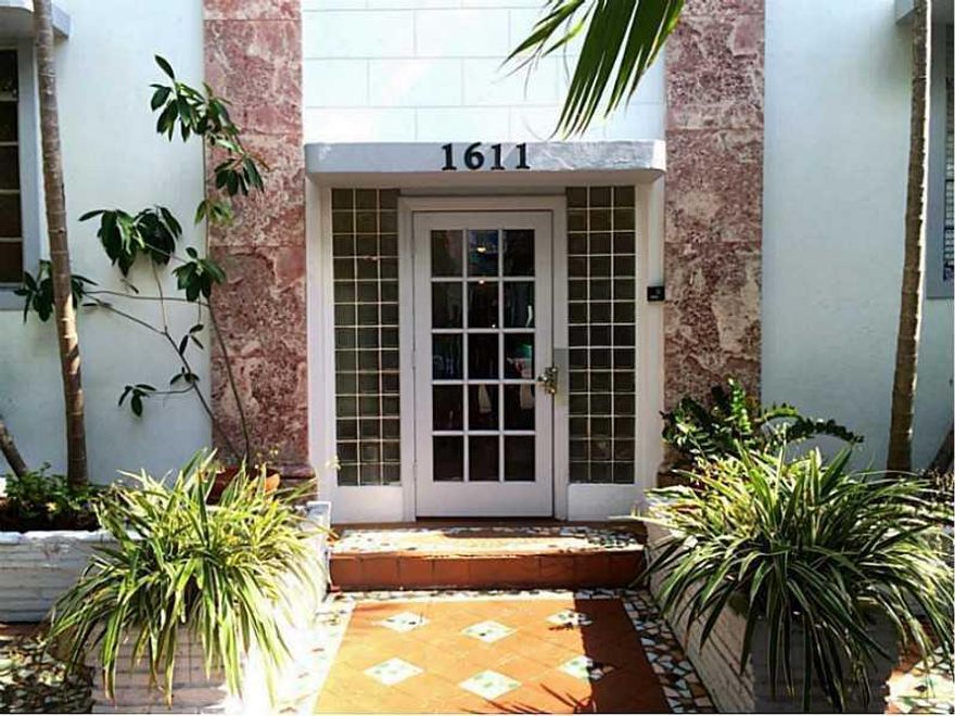 Come and live just 1/2 block from shopping and dining of Lincoln Road. This building features a lushly landscaped  gated courtyard. Perfect for relaxing or working on laptop outside on patio furniture. Large first floor one-bedroom  unit located towards r ear of the building away from street noise. Stunning original hardwood floors, new windows treatments, modern ceiling fans in each room, zig-zag Deco Motife archways, very large living room and more! Large bedroom features walk-in closet with custom close