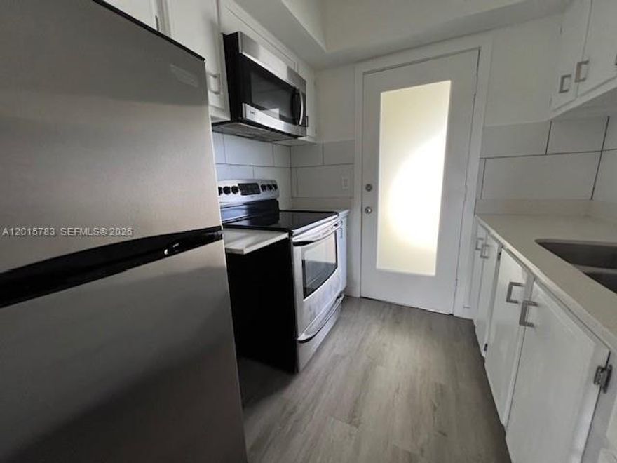 Beautifully renovated third-floor unit in a charming and quiet community! This 1-bedroom, 1-bathroom apartment offers a spacious layout with newer vinyl flooring. The sleek kitchen features stainless steel appliances, quartz countertops, a double steel sink, and plenty of cabinet space. Extra features include large spacious closets and assigned parking. Enjoy the convenience of an additional large storage closet, access to a community laundry room, and a recreation area. Located just east of I-95, this prime location is less than half a mile from US-1 and Lighthouse Point, offering easy access to shopping, dining, and entertainment.
