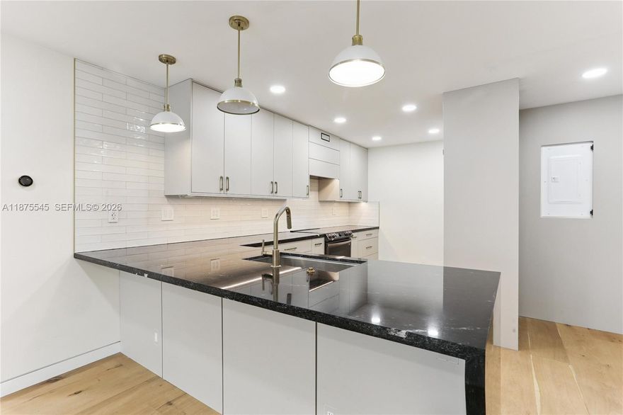 Welcome to your dream home on beautiful, tree lined Edgewater Drive! This completely remodeled unit was updated with permits and features all new electrical & panel, plumbing, and HVAC systems & new ducts. The home boasts custom wide plank oak floors and Lutron Caseta smart switches to control all lights and blinds. Option to lease boat slip lease available.

The kitchen includes custom cabinets with solid brass pulls, Blum hardware, Samsung Bespoke appliances, and quartzite counters. Bathrooms are equally stunning with quartzite counters, Duravit floating toilets, Brizo fixtures, and curbless showers. Other features: custom 7-foot tall pocket doors, new impact windows & doors,, built-in entertainment & bar. 50 Yr Certification Completed