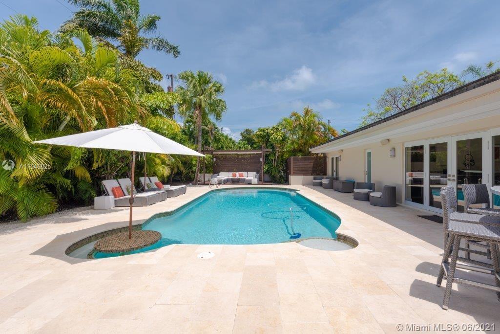 Beautiful, totally renovated one-level home (2014) ADJ SF 3318, filled with natural light in the wonderful Sunrise neighborhood where outdoor living, biking, walking and running are part of everyday life. This home is perfect for entertaining with surround sound throughout the house, a fabulous resort-style backyard with a saltwater, heated pool and a secluded meditation area. This house has a large lot with tropical landscaping. It boasts of a great three split floor plan, with a 3/2 on one side of the house, including a large master en-suite with Jacuzzi. On the other side is a separate guest suite, plus a second master suite with cabana bath.  Other features include a newer roof and impact windows/doors throughout. There is a two car garage and plenty of parking in the circle driveway.