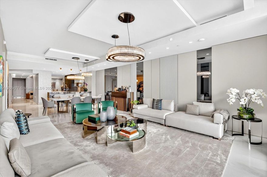 Welcome to The Estates at Acqualina—where luxury meets the ocean. This exceptional turnkey residence, designed by Estudio Jorge Fuentes, is fully furnished and finished to perfection with Fendi Casa and Trussardi Casa décor, Armazem Design millwork, and smart home technology throughout. The primary suite features dual onyx bathrooms, steam shower, freestanding tub, and his & hers dressing rooms. A flow-through layout offers 4 bedrooms, 5 baths, den, media room, service quarters, marble floors, and a private foyer. The open chef’s kitchen with imported stone countertops and top appliances overlooks floor-to-ceiling windows framing breathtaking panoramic ocean views.