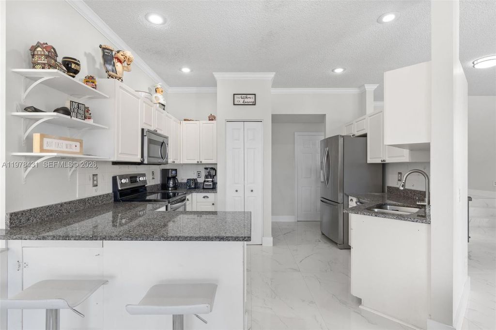 Photo of 9838 NW 1st Mnr, Coral Springs, FL 33071 (MLS # A11978431)