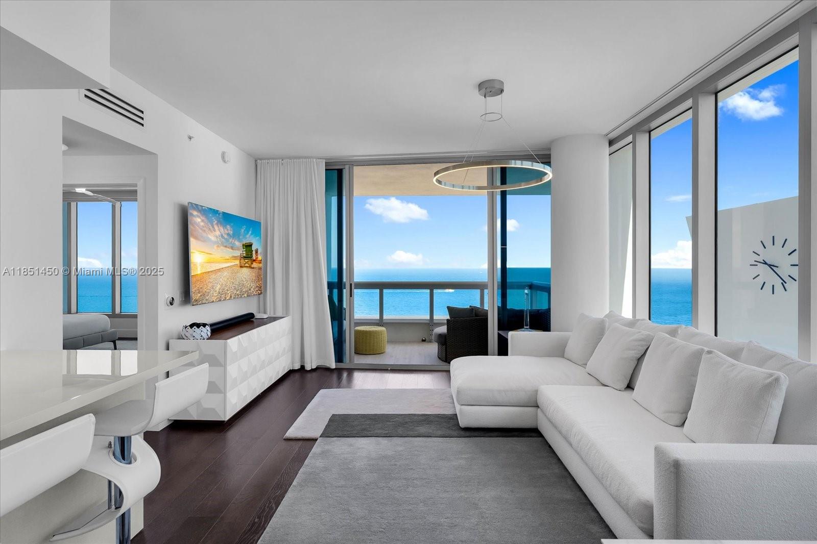 Discover refined oceanfront living in this beautifully renovated and furnished, 2-bedroom, 2-bathroom residence with exquisite ocean views at The Carillon North Tower. Floor-to-ceiling windows and a spacious beachfront terrace provide panoramic vistas of the Atlantic. Unit features include blackout blinds, built-in closets throughout, wide-plank wood floors, elegant marble bathrooms, and a custom kitchen with cabinetry, quartz countertops, and a collection of high-end appliances. The serene primary suite offers ocean views and a spa-like bath with a soaking tub and glass-enclosed shower. Residents enjoy access to The Carillon Miami Wellness Resort’s 70,000 SF spa and fitness center, featuring a range of massage therapies and some of the country’s most innovative wellness treatments.