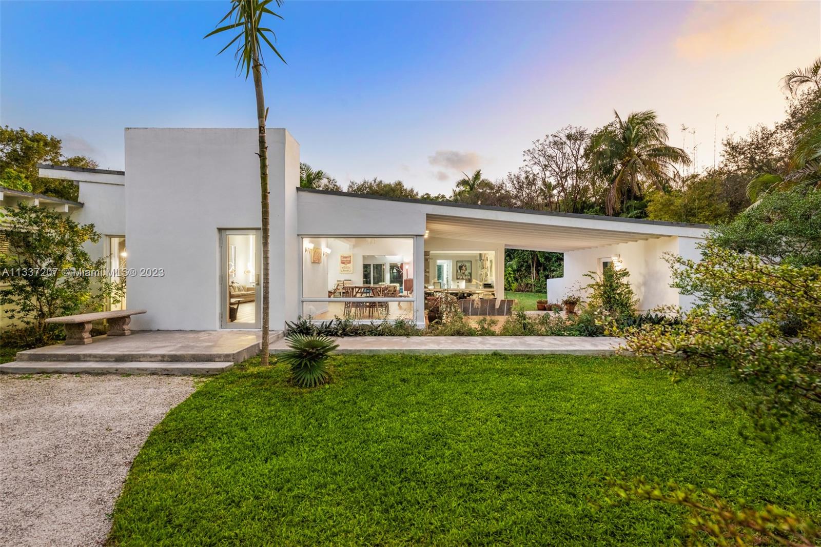 Introducing an extraordinary iconic example of mid-century modern architecture deftly combining the best of both worlds, the desirability of its location and the privacy of a property, with magnificent gardens, on a 39,465 SF lot. Meticulously renovated by current owners in 2015 the home features exquisite wide planks of imported Italian oak wood flooring, dark UV solar tinted impact glass, a formal dining room with garden views that help create a dreamy, floating existence.The well appointed eat in kitchen with top of the line appliances and family room open to a magical garden and glistening pool 8' at its deepest.
The sprawling primary bedroom consists of oversize alcove, walk in closet, stunning tiled bath with soaking tub and transparent rain shower room. This home is a true gem.