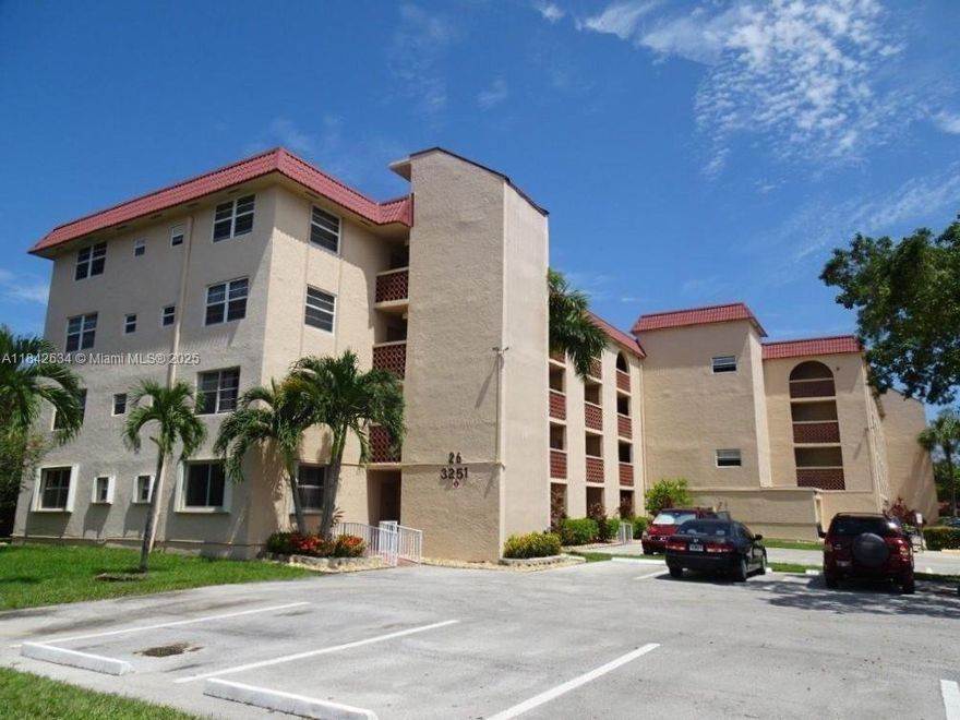 Rarely available, amenity-rich Holiday Springs! Price of this property is lower than previous sales to allow for updates. Larger by 147sf (the size of another bedroom) for this corner penthouse that offers canal & garden views from the screened patio! Features:16x16 tile throughout, updated bath, neutral kitchen with stainless & black appliances, plus same-floor laundry, trash & elevator. Ammenities: heated pool, gym, tennis, pickleball, sauna, fitness classes, social events & more! Quiet, 55+ community with walking paths. Excellent location near Turnpike, Sawgrass, hospitals & more. HOA ($595/mo) incls water, cable, roof repair & reserves. No rentals or pets (except service animals). Min. 650 credit, 20% down, 6 mo of maintenance held in escrow for 18 months.