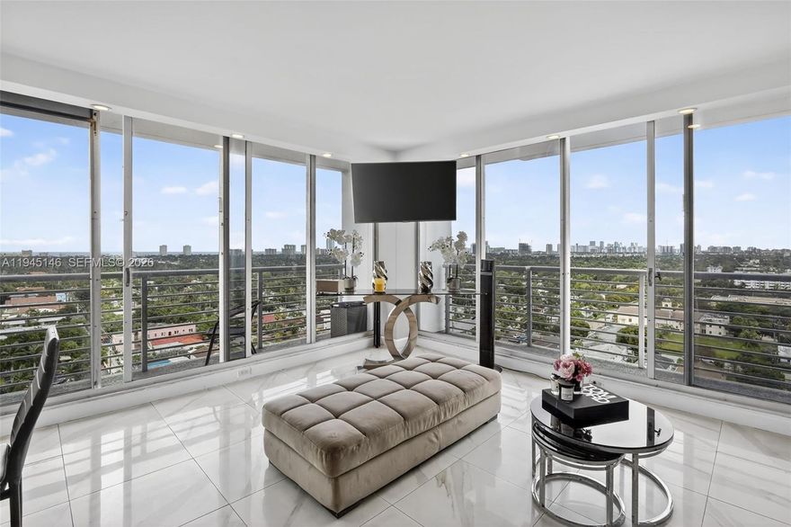 Exceptional value in the heart of Hollywood Circle. This light-filled, high-floor 1BR/2BA residence offers a spacious and flexible layout with modern upgrades, hurricane-impact windows and doors, and expansive views. Floor-to-ceiling, wall-to-wall glass doors frame sweeping vistas of treetops, city skyline, North and South Lake, and all the way to the Atlantic Ocean, filling the open-concept living, dining, and kitchen areas with natural light. Multiple private balconies create a seamless indoor-outdoor living experience ideal for both everyday living and entertaining. Contemporary finishes include upgraded flooring, modern lighting, a sleek kitchen, and renovated kitchen and bathrooms. The generously sized primary suite features a private bath, while the second full bathroom adds convenience for guests or extended stays. Located in a well-maintained, established building, this residence offers comparable views and a walkable urban lifestyle similar to nearby new construction, at a significantly lower price point, creating strong long-term value and upside potential. Enjoy a highly walkable location just steps to restaurants, cafés, nightlife, a large park, shopping, and a supermarket, with the beach only minutes away. Less than 15 minutes to Fort Lauderdale–Hollywood International Airport.