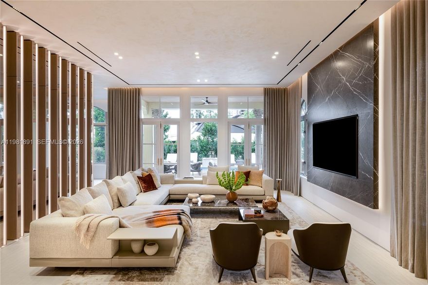 Located in the exclusive gated enclave of Villa Flora in Williams Island, this architectural masterpiece has undergone a meticulous transformation by Troy Dean Homes. With approx. 6,400sf of exquisitely finished interiors, the 6bd, 5ba/3.5ba residence has been thoughtfully redesigned, from bespoke custom millwork and handcrafted fabrications to seamless stone installations and integrated lighting. A multi-level sculptural staircase serves as the focal point upon entry. Warm white oak accents and hand-finished surfaces add depth and texture, creating a cohesive interior that feels both timeless and sophisticated. The chef’s kitchen with top-of-the line appliances and generously appointed living and dining areas on the 1st floor are accessible to the waterfront backyard offering a host of entertaining options. A heated pool/jacuzzi, outdoor kitchen/BBQ and built-in TV provide the ultimate outdoor refuge with marina access. Ascend to the 2nd floor via elevator or illuminated stairs to reach the informal study, two en-suite guest bedrooms and an idyllic Primary Suite complete with two grand walk-in closets, a spa-like bathroom, kitchenette and private patio overlooking the water. Top floor includes expansive family room, two bedrooms, an office/study, fitness room and state-of-the art movie theater. Crestron smart home technology, built-in floor to ceiling wine wall and an air conditioned two-car garage are just some of the key features that make this a one-of-a kind offering.