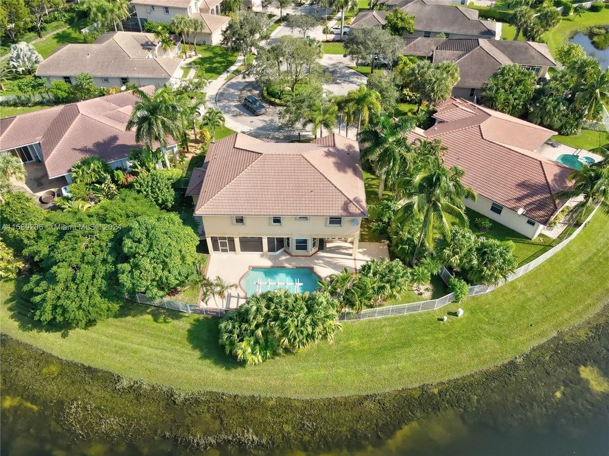 This stunning 6 bedroom 5 bathroom (plus large office) lakefront home with wide water views is perfectly situated on an oversized pie shaped lot at the end of a cul-de-sac. The pool and spa are surrounded by large paver patio and lushly landscaped fenced yard, perfect for entertaining or just relaxing. Double door entry opens to soaring ceilings, formal living room and dining room detailed with marble flooring and upgraded baseboards. Kitchen features breakfast area and overlooks spacious family room. 1 bedroom and den/office downstairs w/master, 4 bedrooms and loft upstairs. Accordion shutters, covered and screened patio. Lawn and pool maintenance included. 1 small pet <20 lbs. Community pool, play area, basketball, ballfields, picnic areas etc. Guard gated. Zoned for top notch schools.