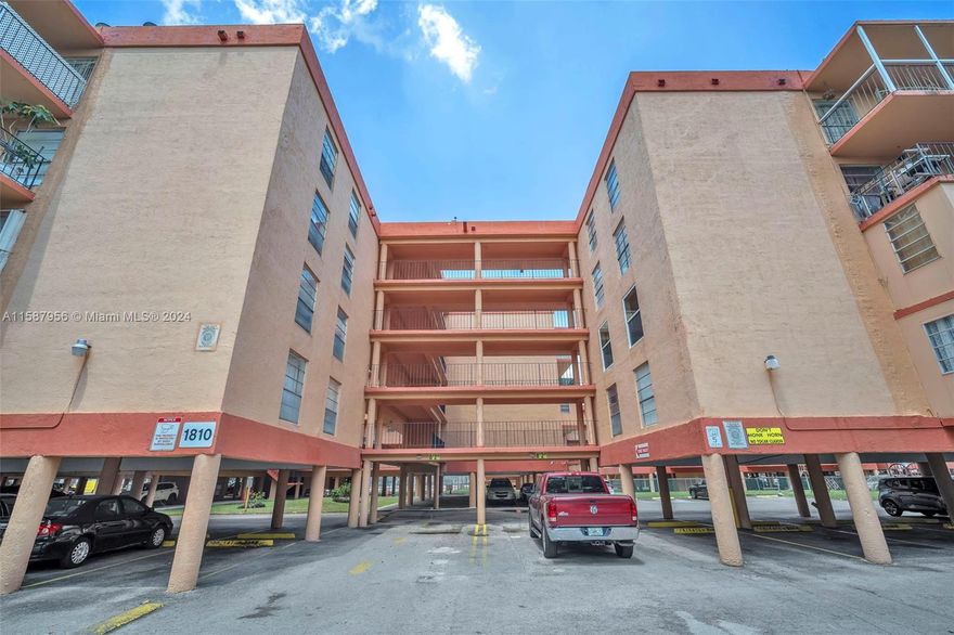 Spacious corner unit condo in Palm East Gardens Condo located across the city park.  It is a 2 bedrooms and 1 bathroom. The kitchen and bathroom were remodeled about 5 years ago.  There is tile flooring and, a white kitchen cabinet that opens into the dining and living room: a spacious screened-in balcony overlooking the pool and the tennis court.  One covered assigned parking space.  The maintenance includes a roof, common area, pool, water, sewer, insurance tennis court common laundry room, the exterior of the building, and secured entrance. ** Seller is willing to help with buyer’s closing cost **