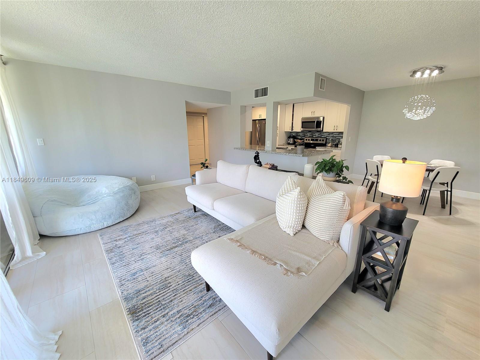 Completely remodeled 2 bedrooms/2 bath in Environ at Lauderhill!! New modern kitchen cabinets, granite countertops with a lovely breakfast bar, and stainless-steel appliances. Remodeled bathrooms, porcelain tiles throughout, large balcony overlooking greenery. Beautifully maintained community surrounded by the Inverrary Golf communities at the cultural center - pool, tennis, pickleball and basketball, bowling, arts & crafts, yoga, fitness gym, sauna and steam rooms, shuffleboard, barbecue area, Internet & water included.