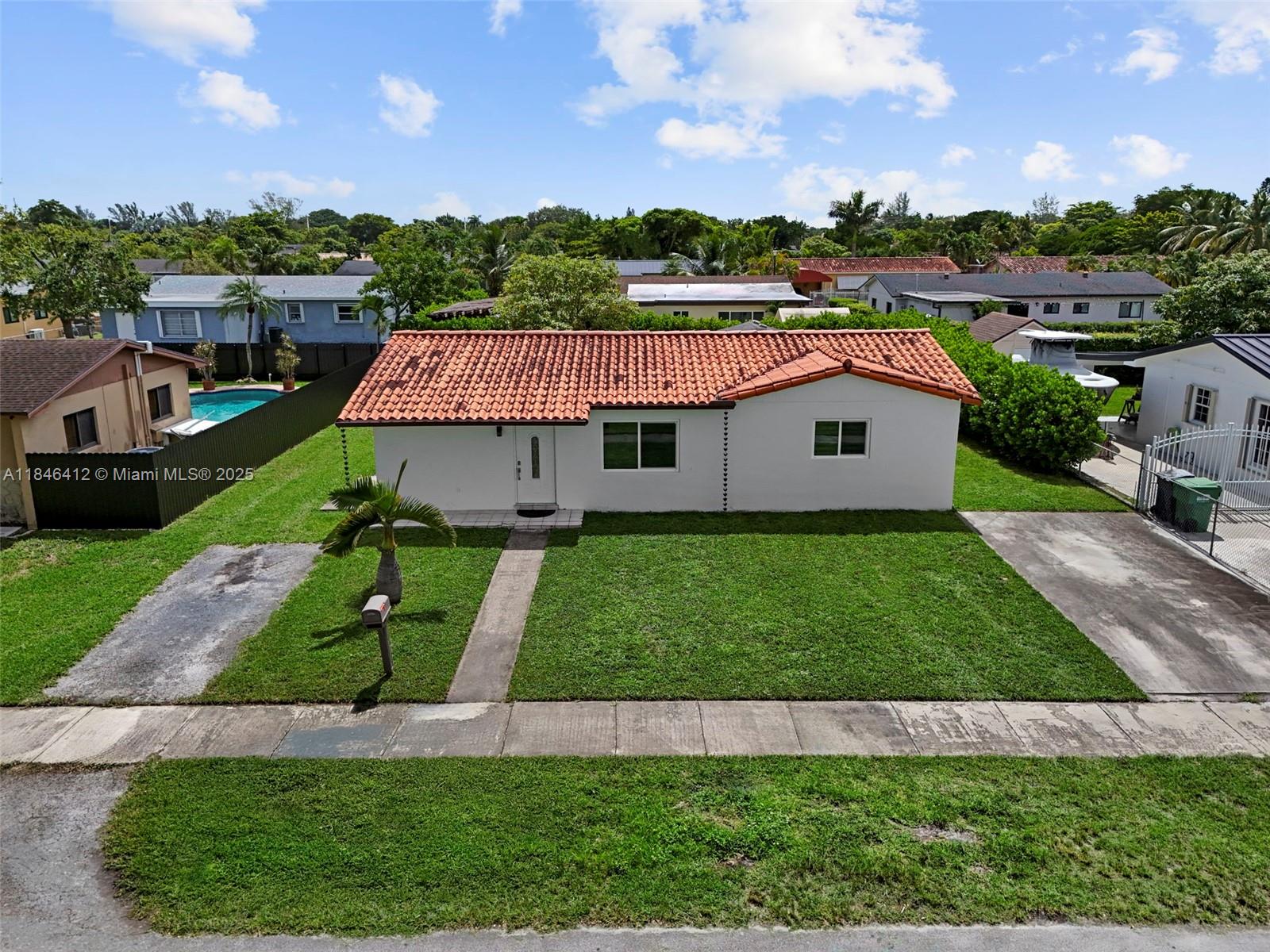 Beautifully maintained 4-bedroom, 2-bathroom home in a prime West Miami location. Property features a spacious layout with tile floors throughout, updated kitchen with wood cabinetry and granite countertops, and a large fenced yard with covered terrace—perfect for entertaining. Garage has been converted and additional living areas offer the potential for a 5-bedroom, 3-bathroom setup, with separate entrances ideal for in-law quarters or income-producing units. Roof and A/C in good condition (buyer to verify), ample parking, and no HOA.