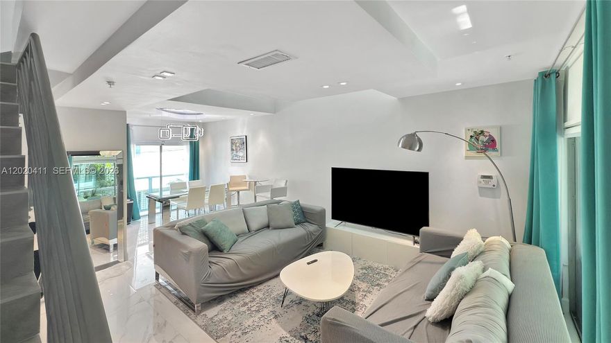 Remodeled trilevel Townhouse with 28 foot ceilings and new white porcelain plank flooring throughout. Very low Maintenance fees. Private rooftop terrace and hot tub. Quiet and secure building with only 7 units. Bright, open living space. Impact windows, 2 bedrooms?, and 2 full bathrooms. Includes 1 assigned covered parking space in a secure garage. Unbeatable location within 2 blocks of the shopping center at Alton Road and 5th Street. Walk to Flamingo Park, the beach, Lincoln Road, shops, and restaurants. Publix, Total Wine, and Whole Foods are just around the corner. This exclusive, private residence offers luxury in a prime location without the hassle of high-rise living, with very low maintenance fees.