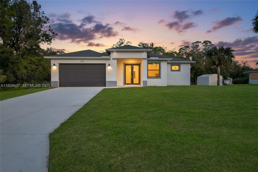 New 2024 Construction on a spacious 1/2 acre lot in Lehigh Acres! Thoughtfully designed with a touch of luxury, this home features 3 beds, 2.5 baths, & a den. This stunning property features 10-ft ceilings, impact windows, and doors that flood the open floor plan with natural light. The modern kitchen boasts granite countertops, ss appliances w sleek finishes. The primary suite offers dual custom closets, double vanities, a freestanding tub, and a separate shower. The expansive backyard is perfect for entertaining, with ample space for a pool, and RV, or boat parking. Located in a serene, family-friendly neighborhood minutes from parks, schools, and shopping on Lee Blvd, this exquisite new construction is move-in ready and waiting for you to make it home. Schedule your showing today!