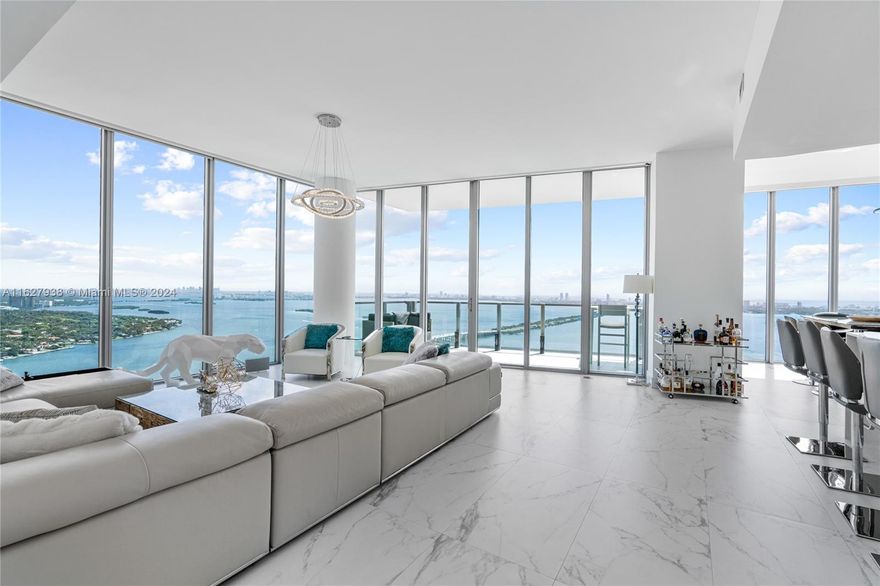 Discover unparalleled elegance in this stunning upper penthouse, featuring 4 bedrooms plus a den and 5 bathrooms. Positioned on the northeast corner, it offers sweeping city and direct Biscayne Bay views through floor-to-ceiling windows. Enjoy high ceilings, a spacious living room, and a high-end kitchen with Snaidero cabinetry and Miele appliances. Biscayne Beach offers resort-style amenities: a fitness center with water views, a 6th-floor pool, beachpool club bar, sand volleyball court, tennis and basketball courts, fire pit, cabanas, business center, beauty salon, and spa facilities. Comes with 2 parking space in the lobby level.