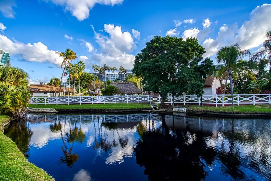 Absolutely gorgeous 1 story townhouse on the water! Waterfront villa in Harbourwood Villas, Three Islands. Spacious and well-maintained 2 bedrooms /2 bathrooms with 1,680 SF of living area on a 2,125 SF lot. Family room may be converted to a potential third bedroom. Stunning Water view from the patio! tranquil pond views and partial marina views from this desirable corner Townhouse! Features include a remodeled kitchen with window, stainless steel appliances, new A/C, high vaulted wood-beam ceilings, impact windows and doors, tile flooring throughout, new water heater, 4 skylights, and 2 walk-in closets. Large paved and covered rear patio ideal for entertaining, plus a welcoming front porch. Two assigned parking spaces directly in front of the unit. Community amenities include pool, tennis courts, racquetball, sauna, and walking paths. Excellent location within walking distance to shops, restaurants, and the beach. Minutes to Gulfstream Park and close to two international airports.