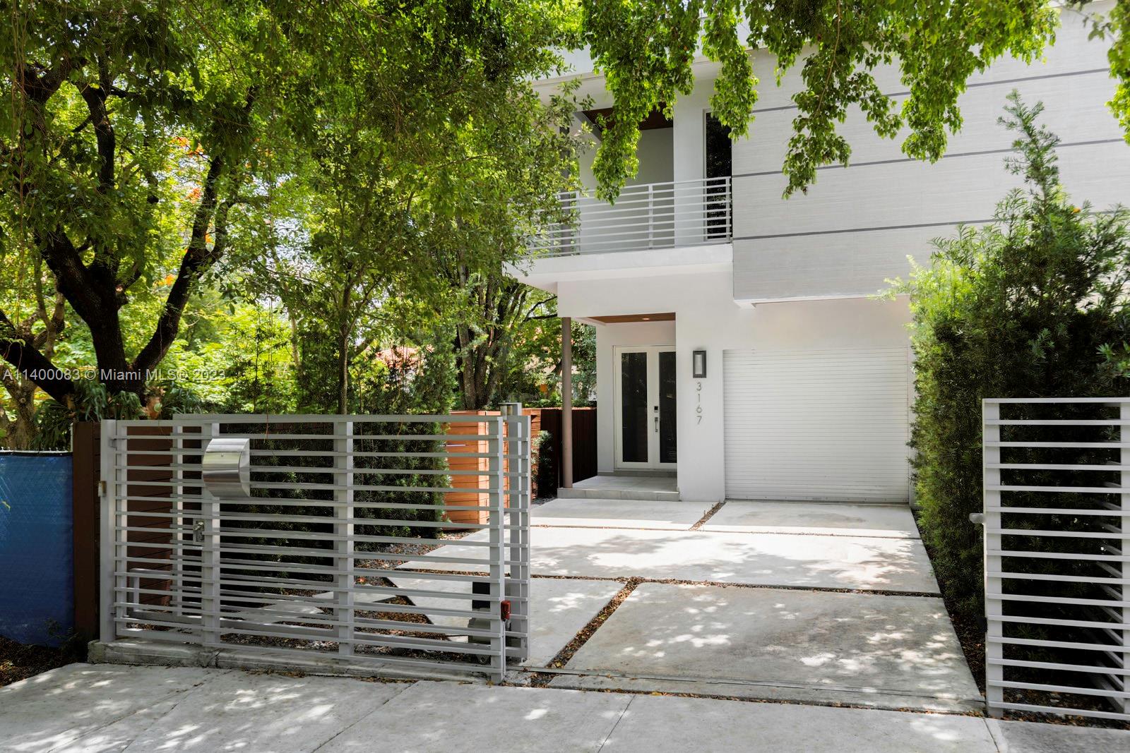 Spectacular, gated Tropical Modern townhome in prime Center Grove location. Gifford Lane is a quiet, tree-lined street known for its yearly “Gifford Art Stroll”. Just a 2 block walk to the Grove village center’s galleries, boutiques, cafes and bayfront parks & marinas. Enter into light-filled & expansive living spaces w/ soaring ceilings & wood-plank style porcelain tile flooring. Ideal open layout features European style kitchen w/cooking island adjacent to family room overlooking the heated pool w/waterfall & lush, ultra-private garden. 3 large bedrooms (all en-suite)+ full cabana bath. Primary suite offers custom built walk-in closet & spa-like bath w/soaking tub & glass enclosed shower. Enjoy year-round outdoor living on the deep covered terrace & roof-top terrace w/outdoor views.