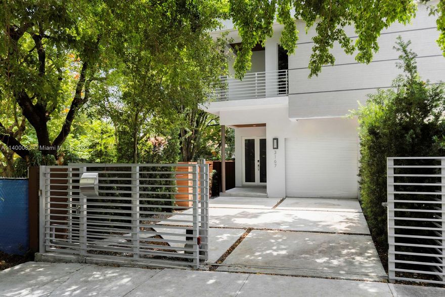 Spectacular, gated Tropical Modern townhome in prime Center Grove location. Gifford Lane is a quiet, tree-lined street known for its yearly “Gifford Art Stroll”. Just a 2 block walk to the Grove village center’s galleries, boutiques, cafes and bayfront parks & marinas. Enter into light-filled & expansive living spaces w/ soaring ceilings & wood-plank style porcelain tile flooring. Ideal open layout features European style kitchen w/cooking island adjacent to family room overlooking the heated pool w/waterfall & lush, ultra-private garden. 3 large bedrooms (all en-suite)+ full cabana bath. Primary suite offers custom built walk-in closet & spa-like bath w/soaking tub &  glass enclosed shower. Enjoy year-round outdoor living on the deep covered terrace & roof-top terrace w/outdoor views.