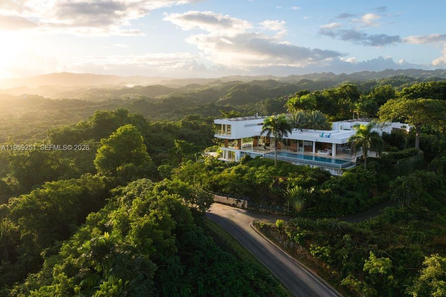 Built in 2012 and thoughtfully enhanced in 2025, Villa Aura is a statement of elevated Caribbean living, commanding one of the most breathtaking vantage points in Las Terrenas. Upon arrival, sweeping panoramic views of the ocean, rolling mountains, and lush tropical landscapes unfold in every direction. Perched at the highest elevation within the exclusive gated enclave of Loma Esperanza, the estate enjoys unobstructed 360-degree vistas. Spanning approximately 7,000 square feet on a 55,972-square-foot parcel, the home offers six bedrooms, six full baths, and three half baths designed for seamless indoor-outdoor living. Highlights include a European open-concept kitchen, infinity pool, expansive terraces, fruit gardens, refined finishes, resilient infrastructure, and approved expansion plans—creating a legacy retreat where luxury and nature exist in perfect harmony.